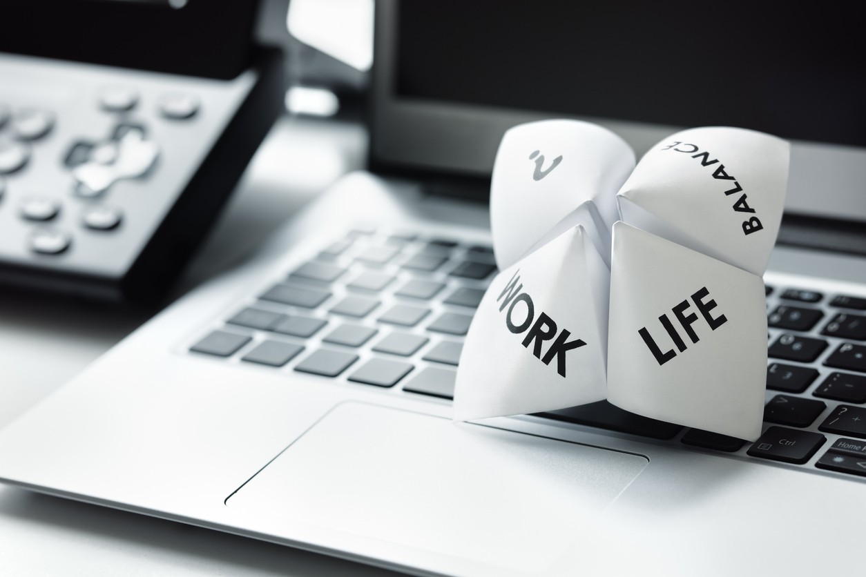 Laptop keyboard with paper, life, work, balance selector